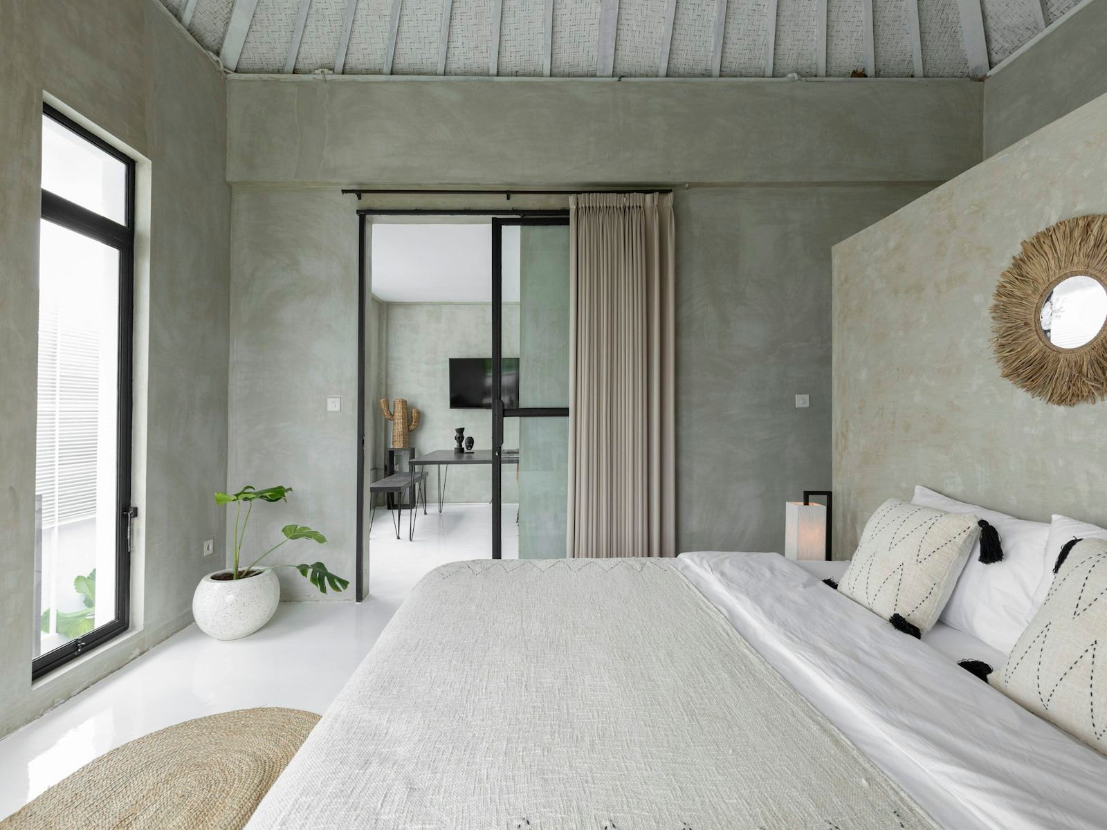 Bedroom with white linen and glass doors to the garden