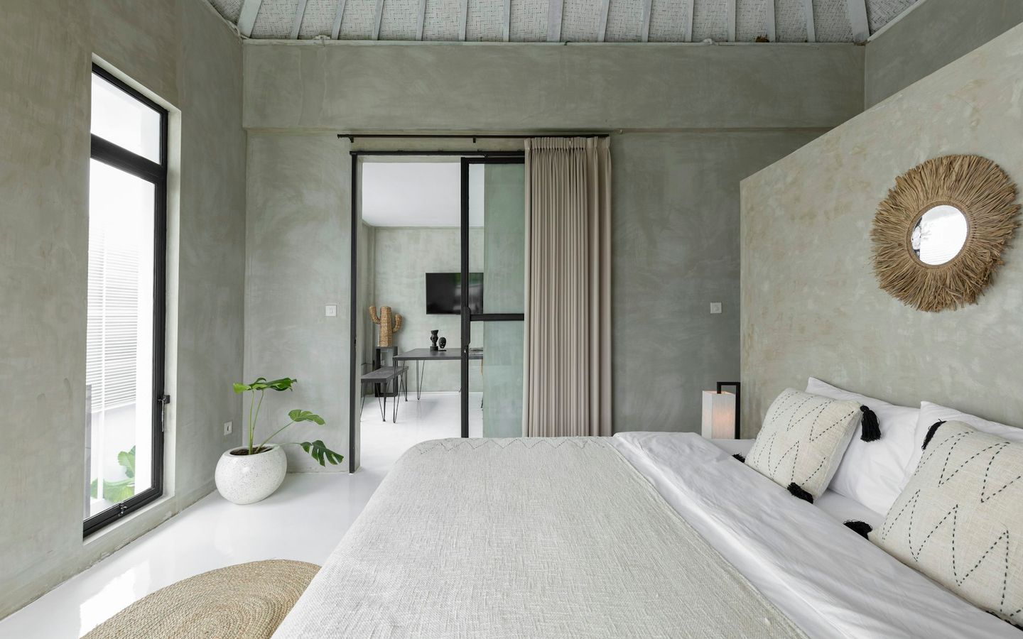 Bedroom with white linen and glass doors to the garden